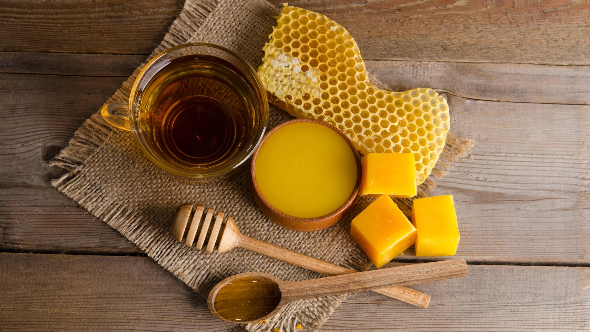 A table with beeswax, honey and honeycomb.